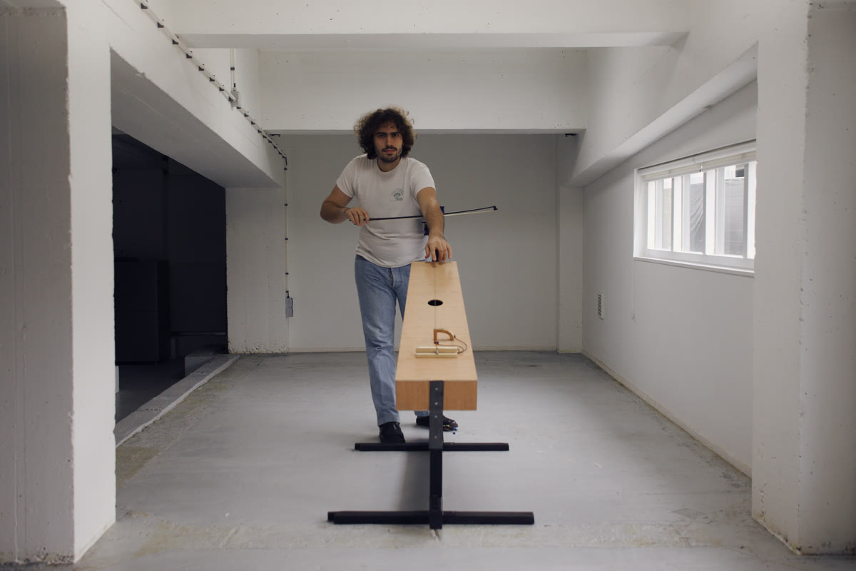 Photograph of Lorenzo Servali playing the trombone marino, seen from the front down the length of the body