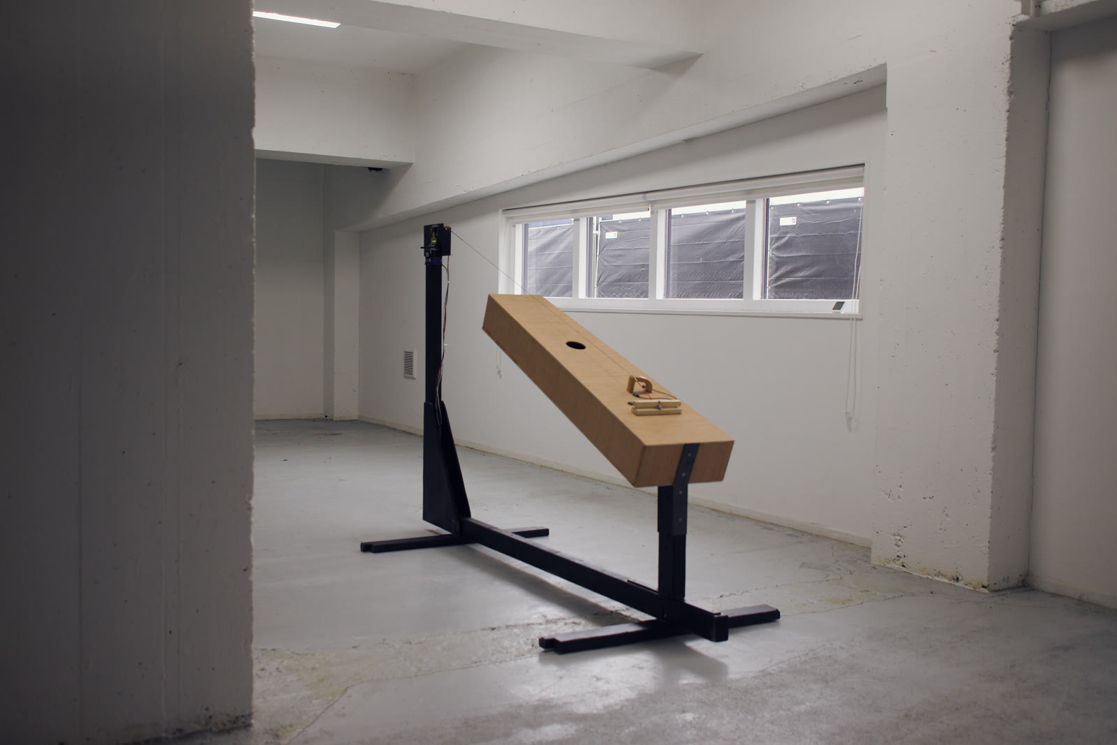 The trombone marino on its steel frame in an empty white room